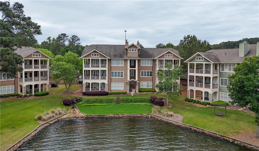 117 South Bay Road, Unit 402 Eatonton, GA 31024 - Photo 10 of 48 a view of a big house with a big yard and potted plants