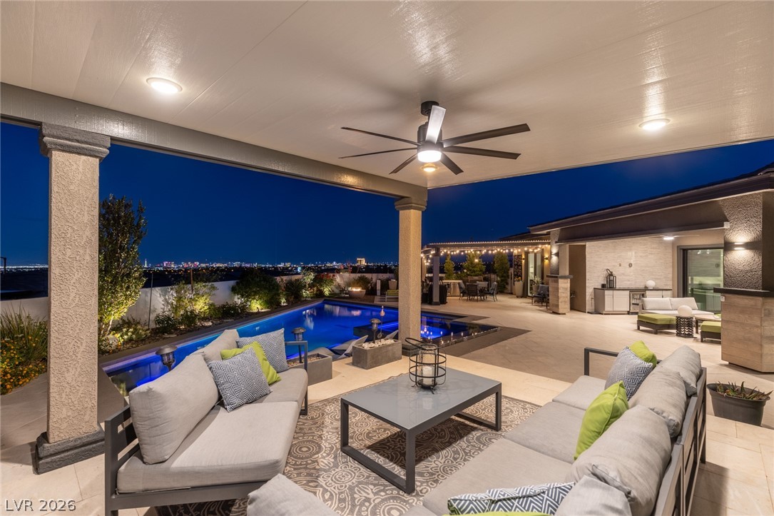 10118 Copper Edge Road Las Vegas, NV 89148 - Photo 36 of 48 An inviting outdoor living space with city lights and a pristine pool.