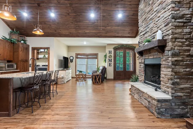 a living room with furniture wooden floor and a fireplace