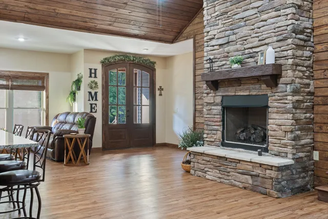 a spacious bedroom with a large bed and a chandelier