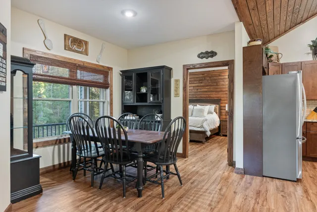 a bedroom with a bed and large windows