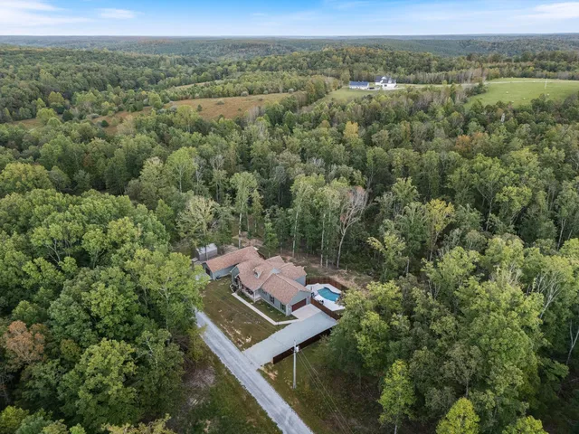 an aerial view of a house with a yard