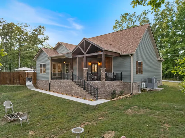 a view of a house with backyard porch and sitting area