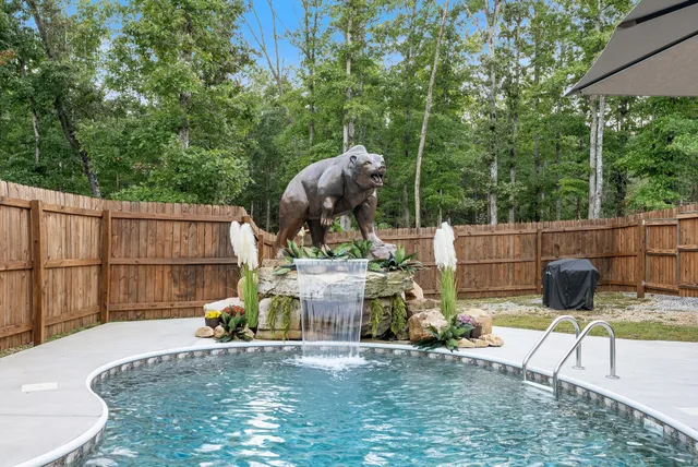 a view of a patio with table and chairs and a barbeque