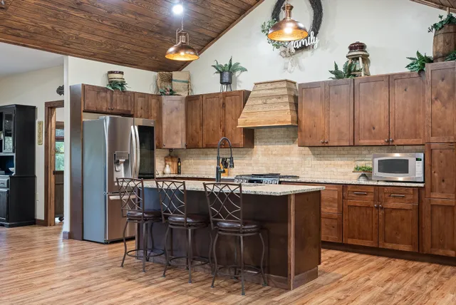 a kitchen with a table chairs and a refrigerator