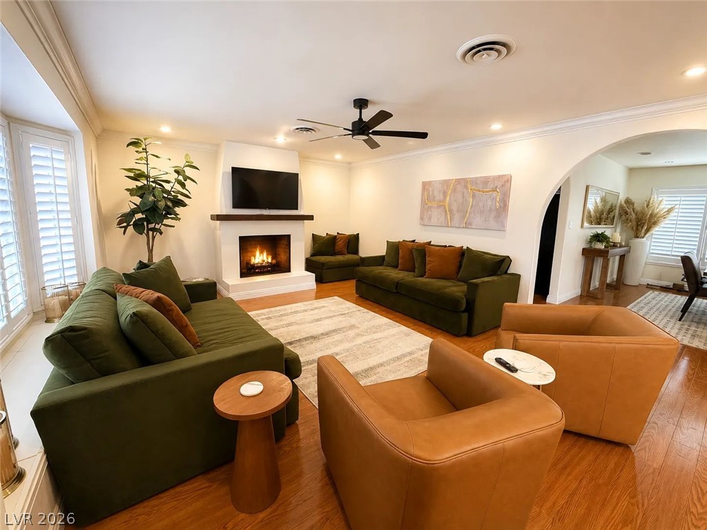 3010 East Viking Road Las Vegas, NV 89121 - Photo 9 of 48 A welcoming living area featuring a cozy fireplace and polished hardwood flooring, perfect for gatherings.