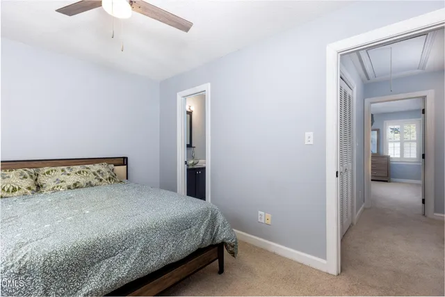 a bedroom with a bed a window and closet