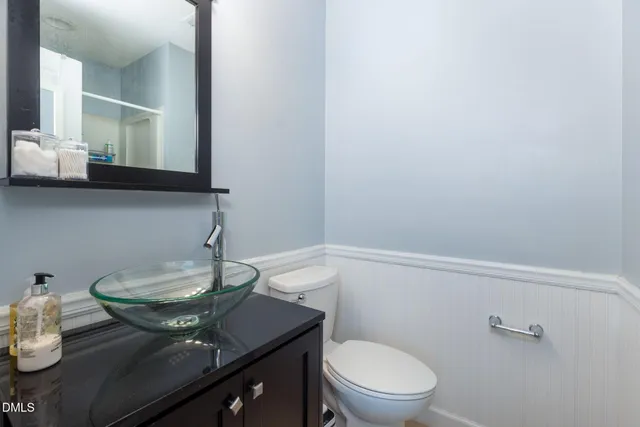 a bedroom with a bed and a mirror