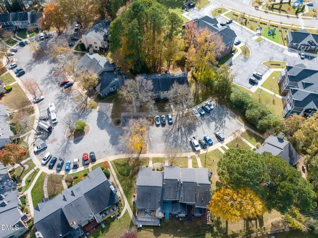 an aerial view of a house with a swimming pool and outdoor seating