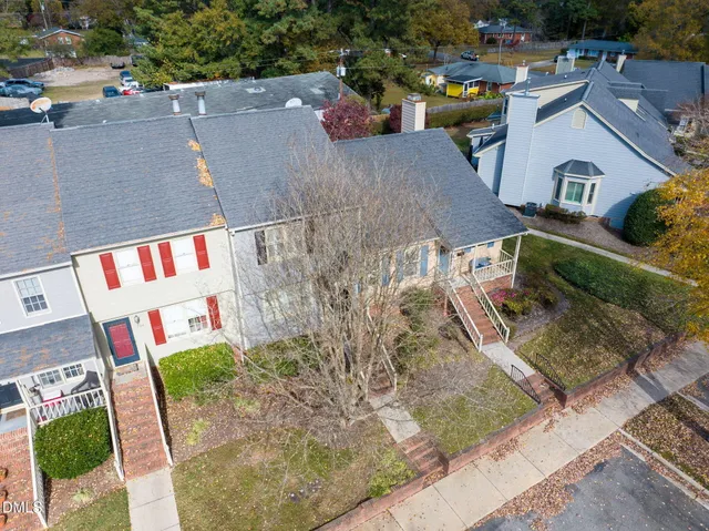 an aerial view of a house with a yard