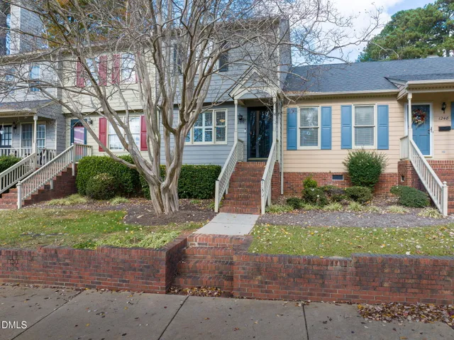 front view of a brick house with a yard