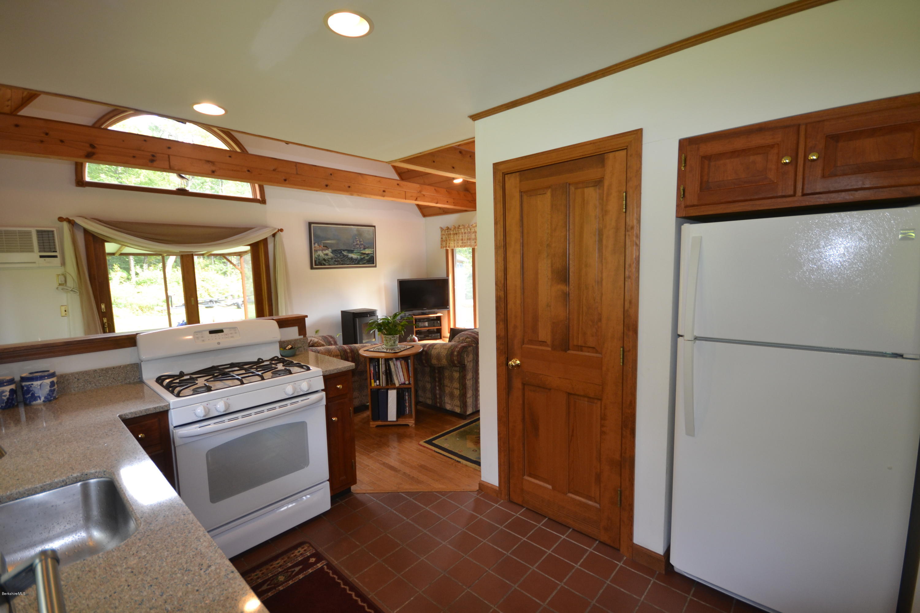 18 Baumann Road Peru, MA 01235 - Photo 17 of 52 a kitchen with a refrigerator a stove top oven a sink and cabinets