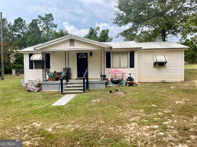 3 Wilson Road Kite, GA 31049 - Photo 1 of 1 a backyard of a house with table and chairs