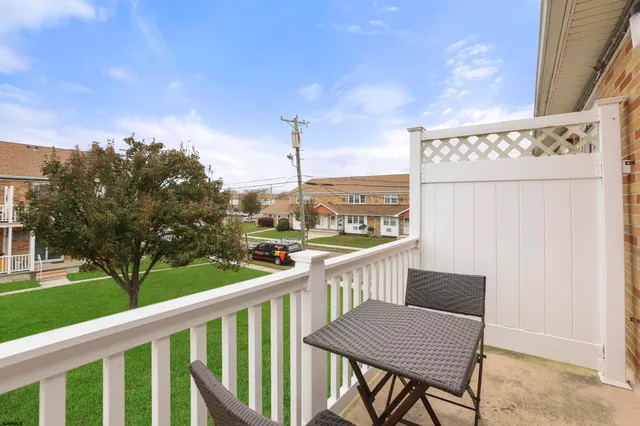 a view of a chairs and table in patio with a yard