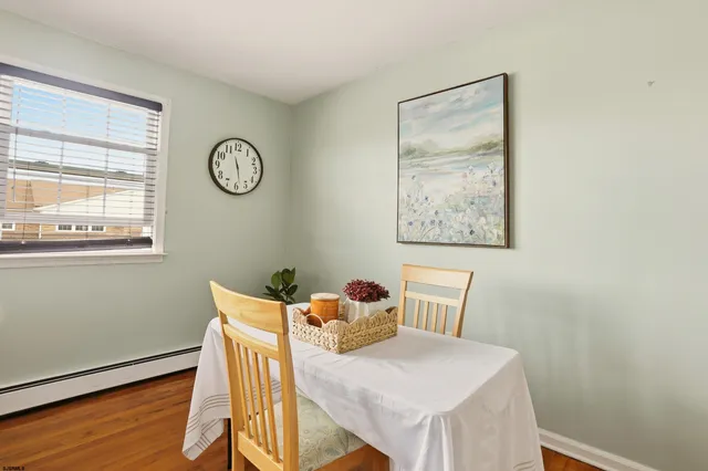 a dining room with furniture and wooden floor