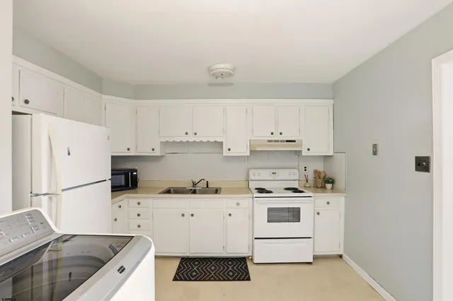 a bathroom with a sink mirror vanity and toilet