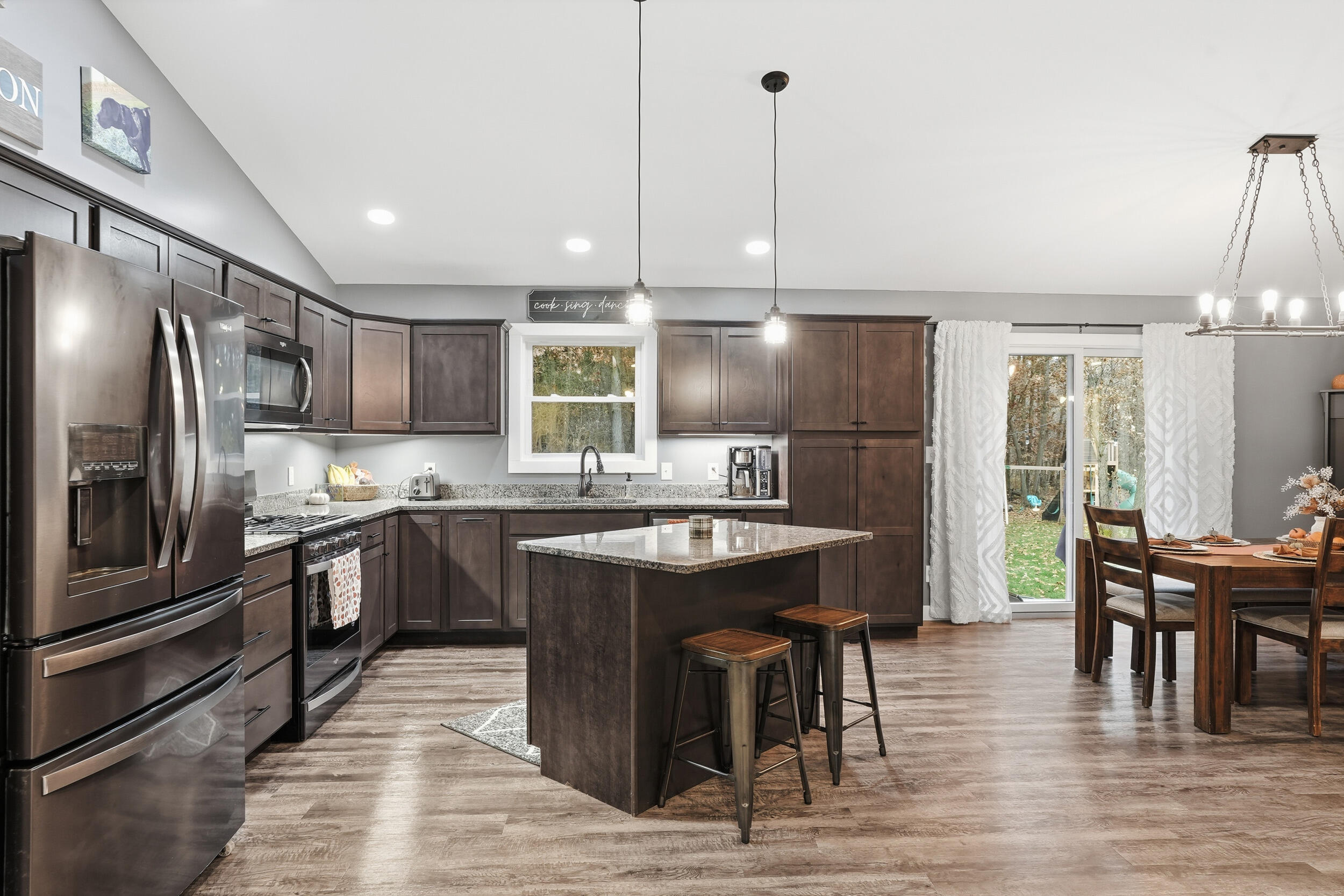 10385 Lakota Court Demotte, IN 46310 - Photo 13 of 29 a kitchen with kitchen island granite countertop a sink and stainless steel appliances