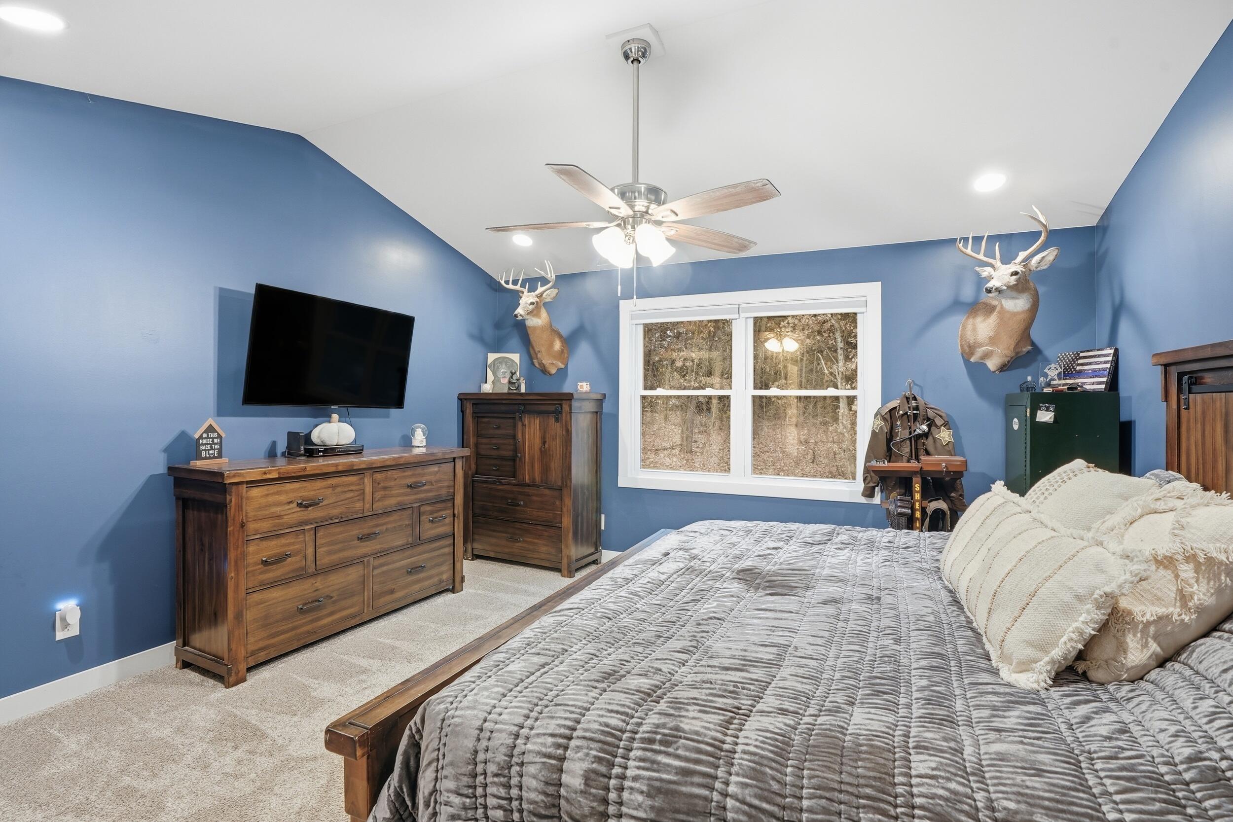 10385 Lakota Court Demotte, IN 46310 - Photo 23 of 29 a bed room with furniture and a flat screen tv