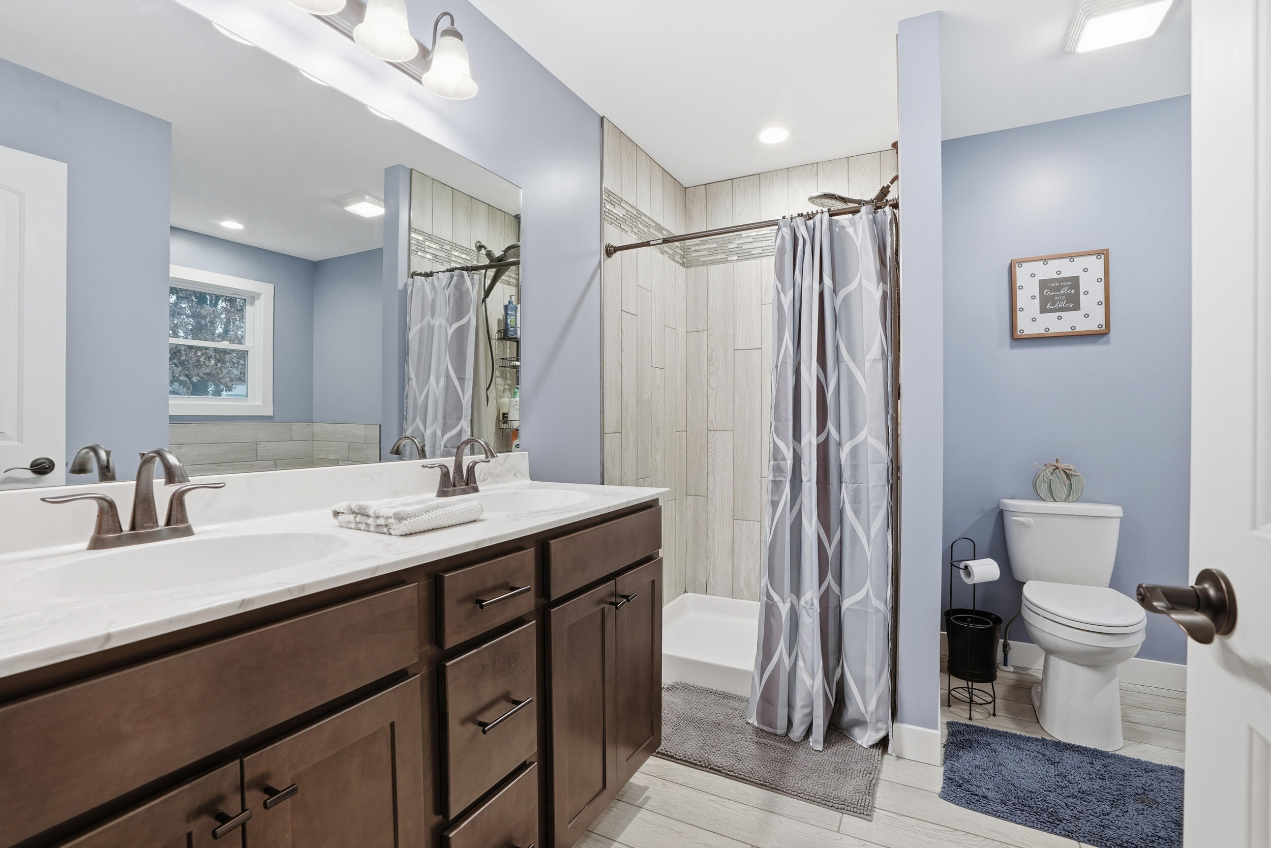 10385 Lakota Court Demotte, IN 46310 - Photo 25 of 29 a bathroom with a double vanity sink toilet and shower