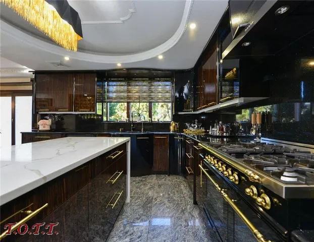 a kitchen with a stove and a wooden floor