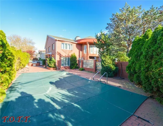 an outdoor living room with furniture a mirror and windows
