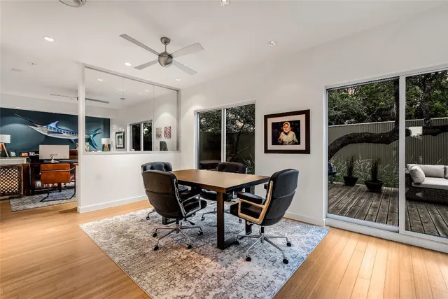 a dining room with furniture and wooden floor