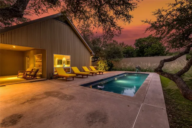 a view of backyard with swimming pool table and chairs
