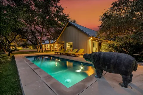 a view of swimming pool with outdoor seating and plants