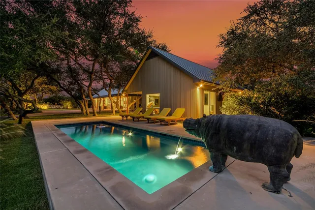 a view of swimming pool with outdoor seating and plants