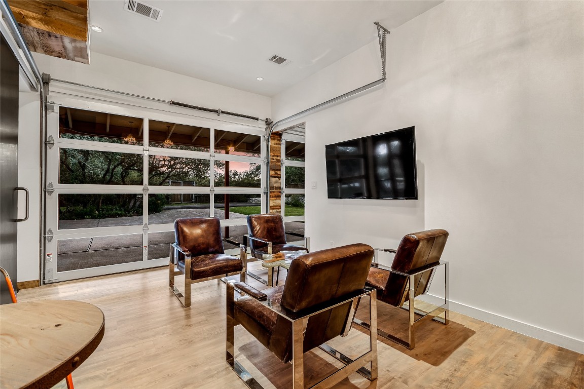 2606 Ranch Road 620 North Austin, TX 78734 - Photo 7 of 28 a living room with furniture a flat screen tv and floor to ceiling window