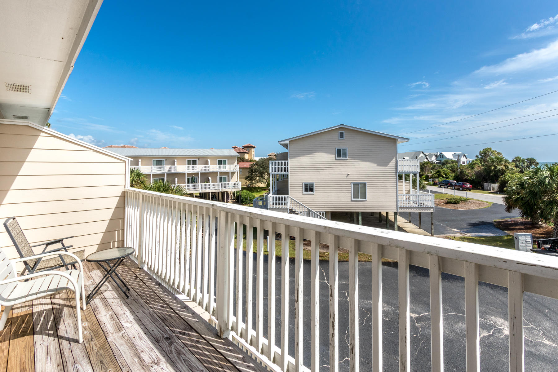 191 Blue Mountain Road, Unit 202 Santa Rosa Beach, FL 32459 - Photo 14 of 31 a view of a balcony with wooden floor and fence