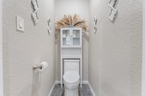 a bathroom with a toilet and a shower curtain
