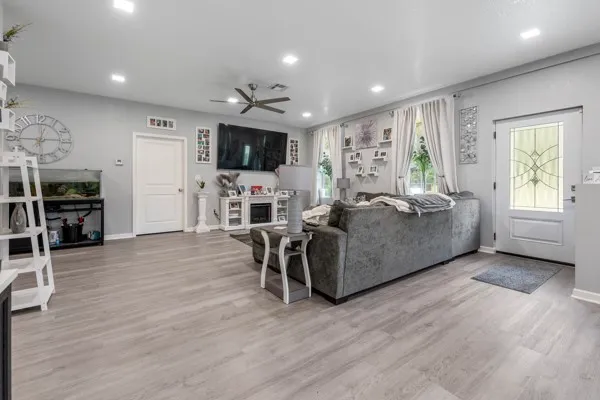 a living room with furniture fireplace and flat screen tv