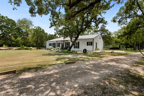 a house with swimming pool in front of it