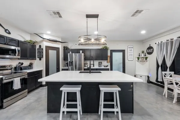 a large kitchen with a table and chairs