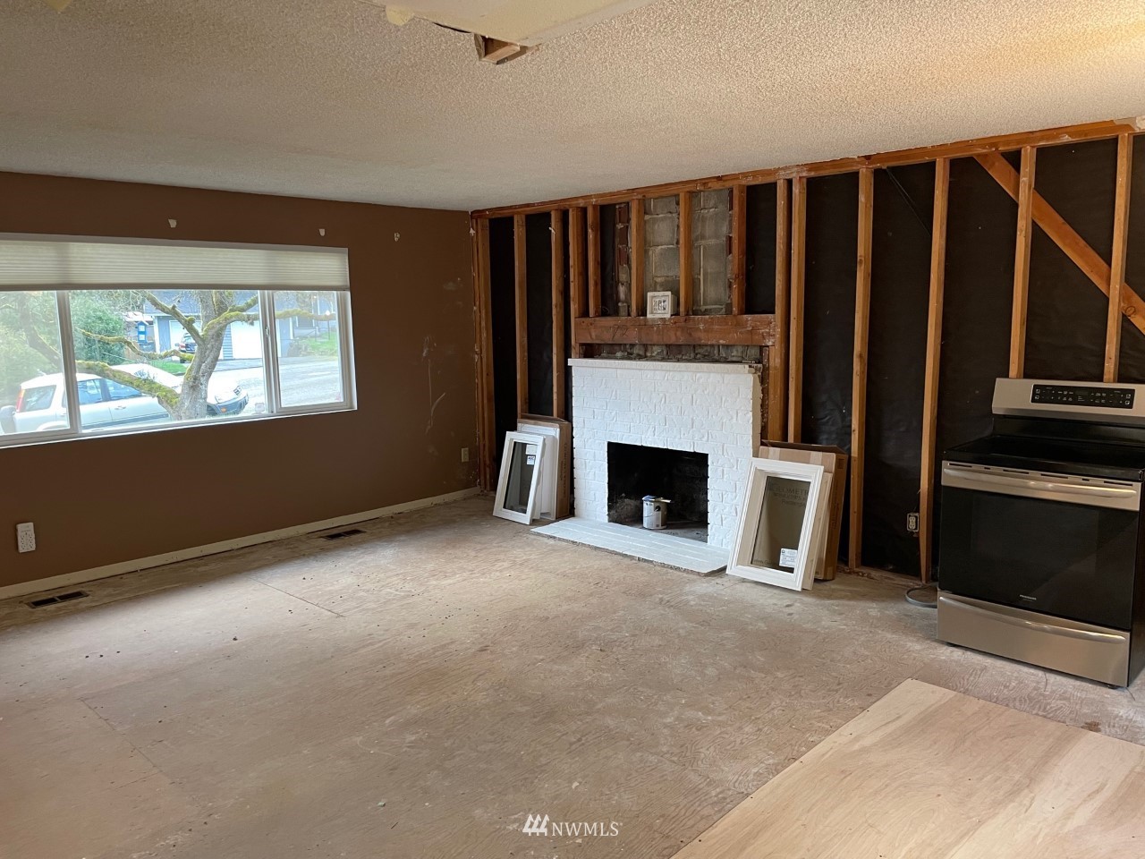22020 5th Avenue West Bothell, WA 98021 - Photo 2 of 12 a view of an empty room with a fireplace and a window