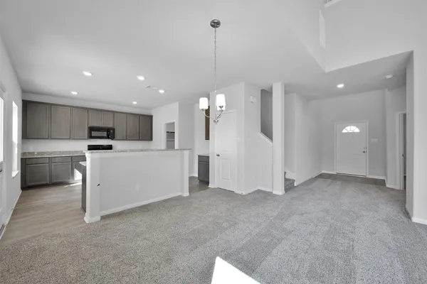 a view of a kitchen with a sink and a refrigerator