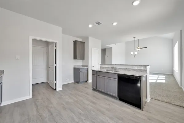 a large kitchen with a stove and a refrigerator