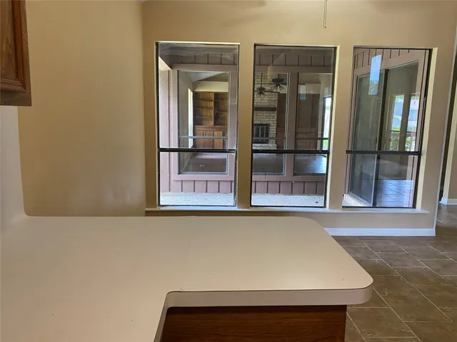 an empty room with furniture and natural light