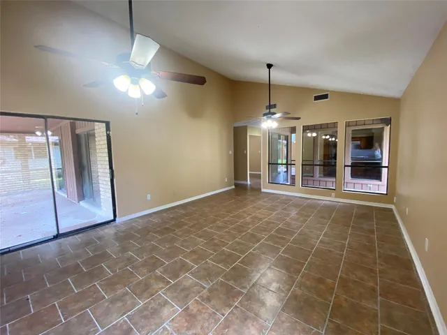 a view of a livingroom with a ceiling fan and window