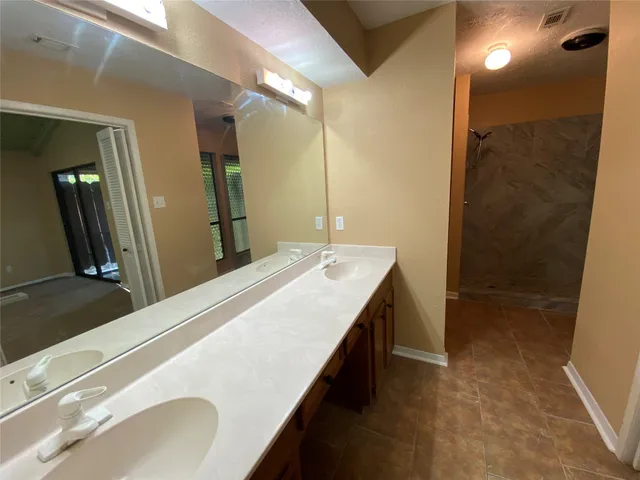 a bathroom with a sink double vanity and a mirror