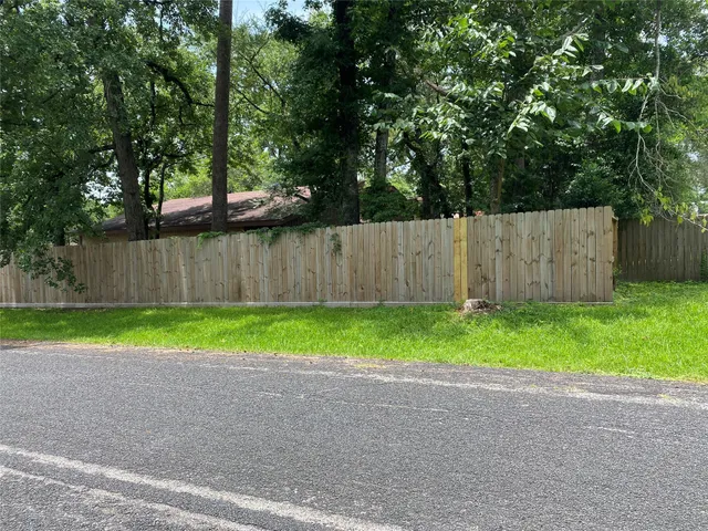 an empty room with a ceiling fan and window