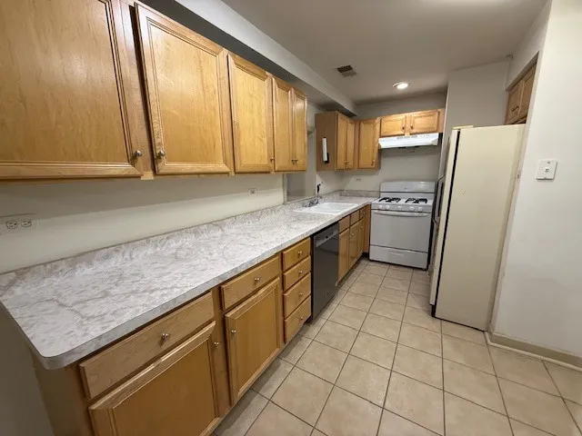 a kitchen with a sink stove and refrigerator