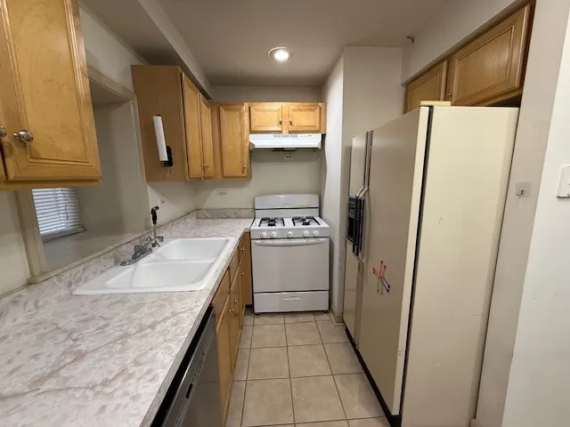 a bathroom with a sink a toilet a mirror and bathtub