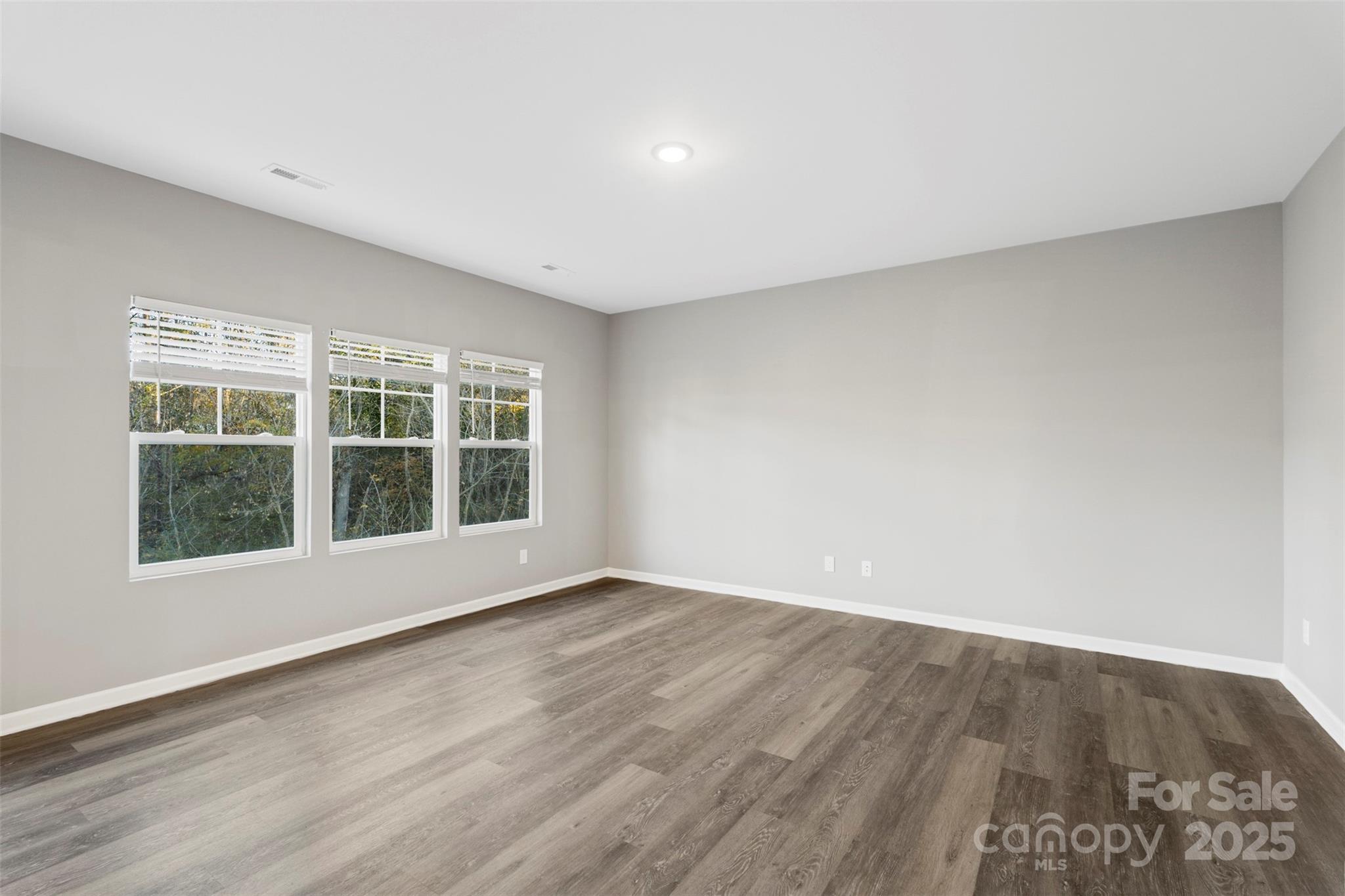 265 Prospect Trail Salisbury, NC 28147 - Photo 12 of 44 a view of an empty room with wooden floor and windows