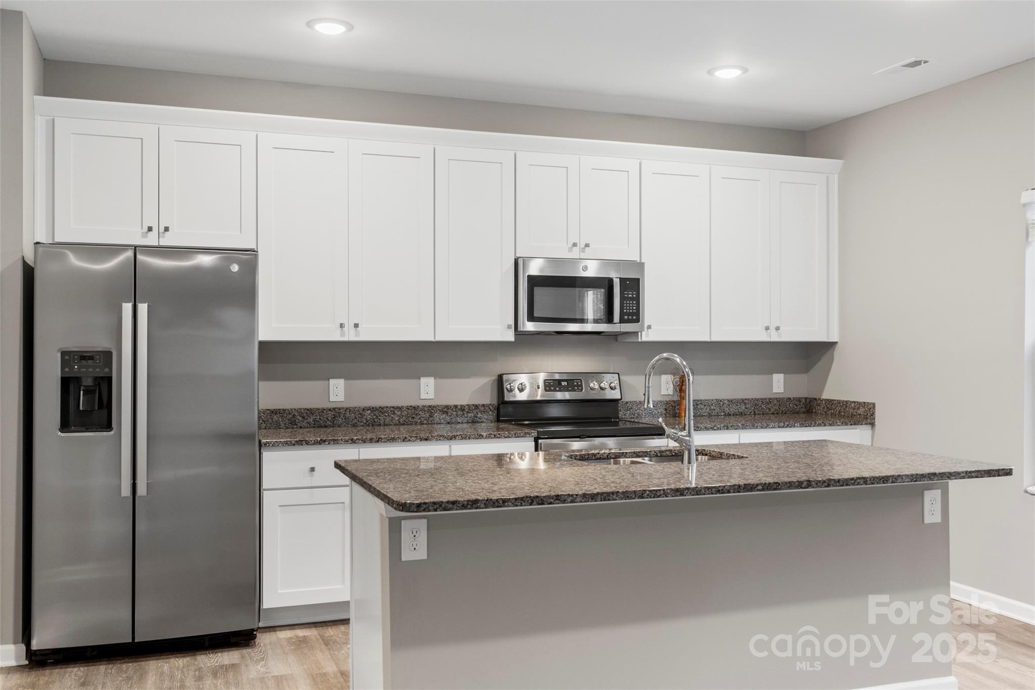 265 Prospect Trail Salisbury, NC 28147 - Photo 19 of 44 a kitchen with stainless steel appliances granite countertop a refrigerator a stove a sink and white cabinets