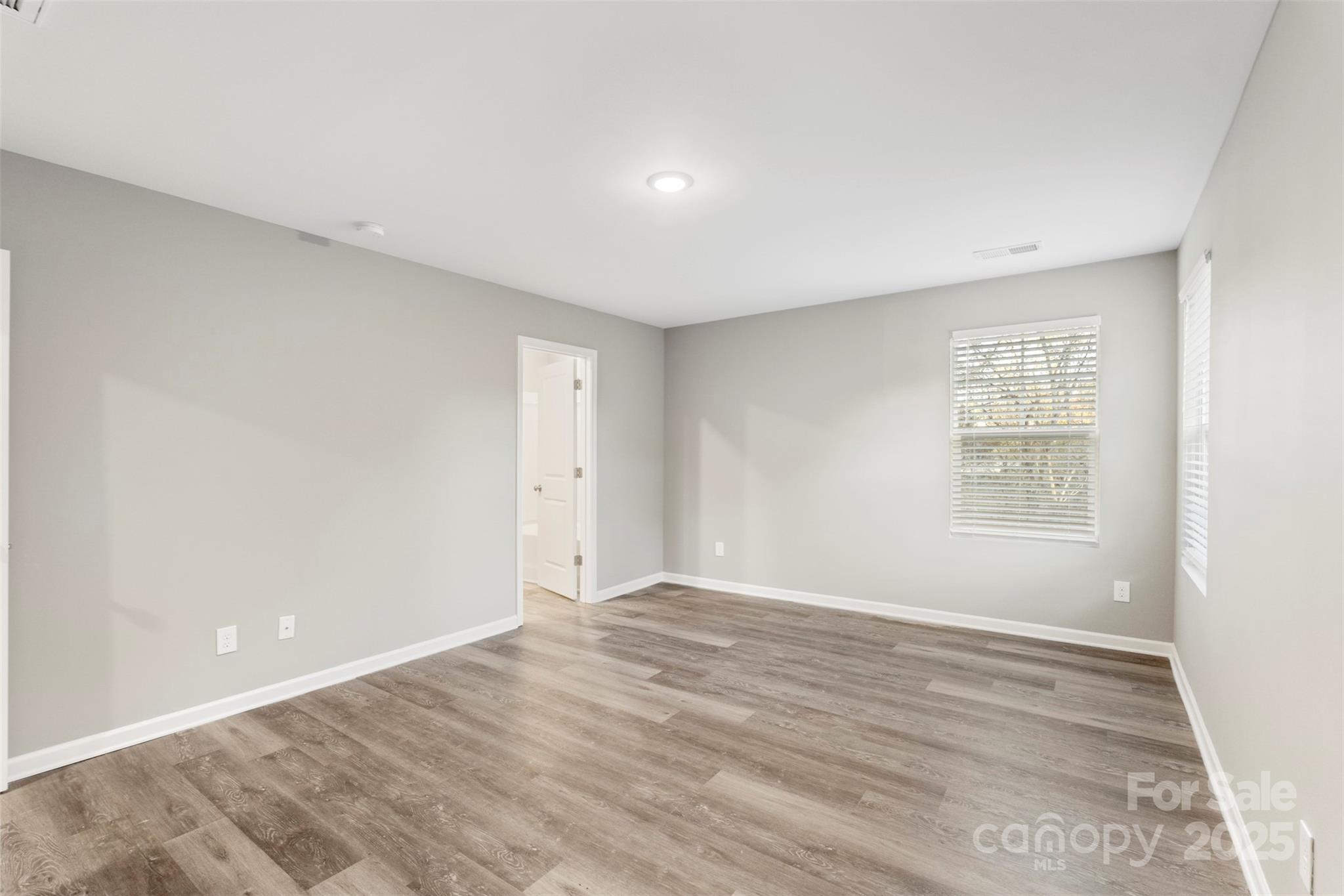 265 Prospect Trail Salisbury, NC 28147 - Photo 27 of 44 a view of an empty room with wooden floor and a window