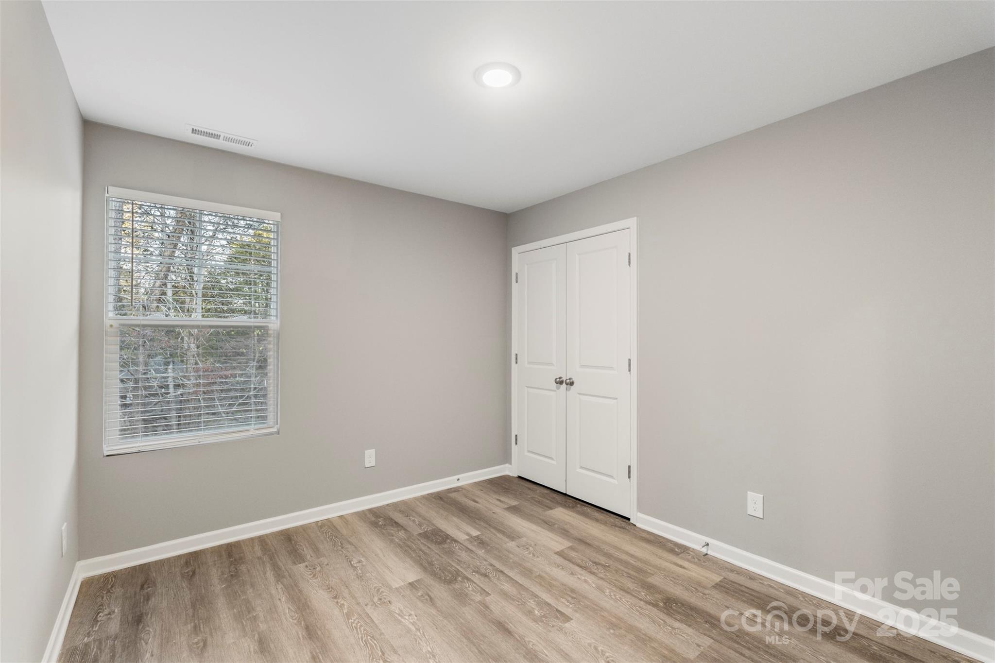 265 Prospect Trail Salisbury, NC 28147 - Photo 38 of 44 a view of an empty room with wooden floor and a window
