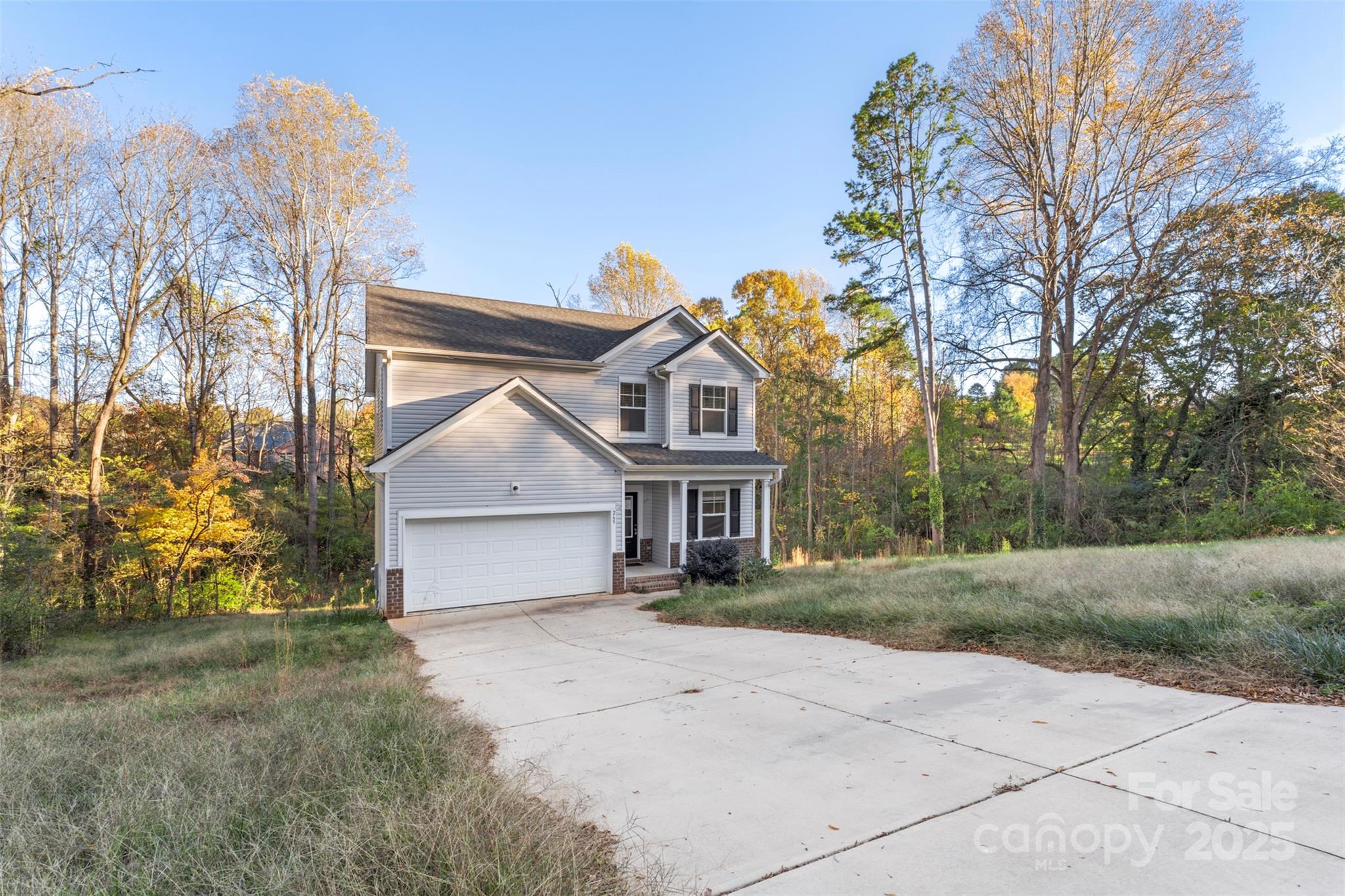 265 Prospect Trail Salisbury, NC 28147 - Photo 4 of 44 a front view of a house with a garden and trees