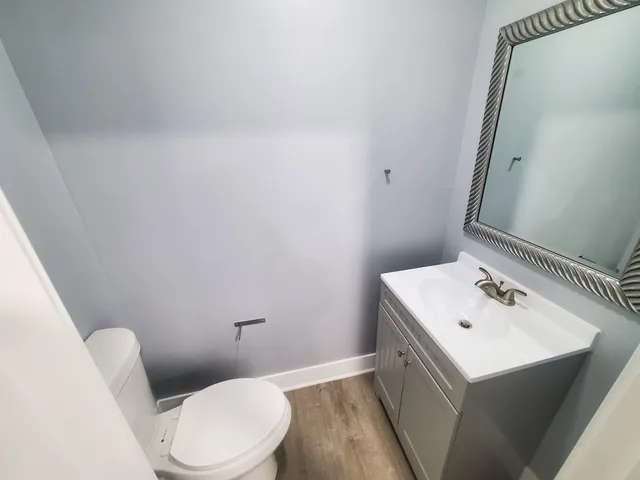 a white toilet sitting next to a bathroom sink
